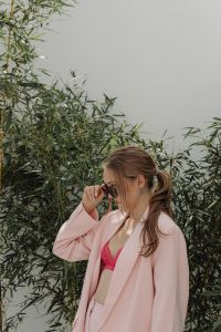 Kaboompics - Woman Adjusting Sunglasses in a Pale Pink Blazer