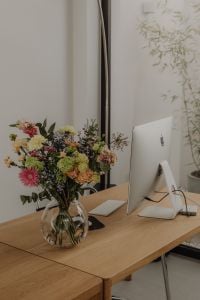 Kaboompics - Glass Vase Bouquet and Silver Desktop Computer by the Window