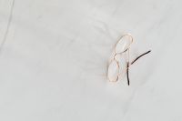 Kaboompics - Minimal Gold Eyeglasses With Long Shadows On Marble