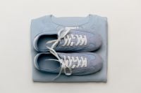 Kaboompics - Blue Sneakers on a Folded Sweatshirt