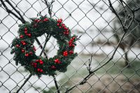 Kaboompics - Holly Berry Wreath Hanging on a Wire Fence