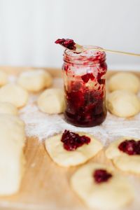 Kaboompics - Cherry Jam Jar and Gold Spoon with Dough Rounds