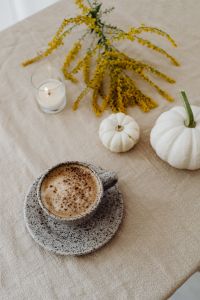 Kaboompics - Autumn Table Still Life with Glass Candle, Cappuccino, Goldenrod and White Pumpkins