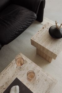 Kaboompics - Open Book on Travertine Table beside Black Sofa