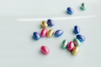 Kaboompics - Three Separate Groups of Foil-Wrapped Easter Eggs on White