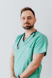 Kaboompics - Smiling Doctor in Mint Scrubs and Stethoscope, Vertical Medical Campaign Portrait