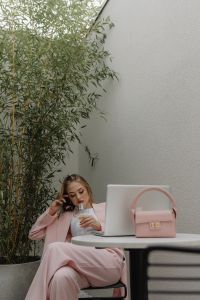 Kaboompics - Woman Relaxing Beside a Laptop and Pink Handbag