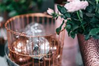 Kaboompics - Rose Gold Christmas Ornaments in a Decorative Wire Basket