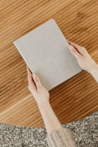 Kaboompics - Overhead View of Hands Holding a Daily Planner