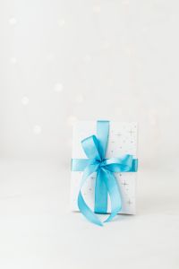 Kaboompics - Small Blue-Ribbon Gift at Bottom of a Light Bokeh Background