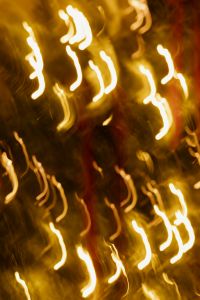 Kaboompics - Abstract Golden Christmas Tree Light Trails with Red Ribbon