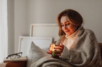 Kaboompics - Cozy Stay-at-Home Evening: Woman with Candle and Book