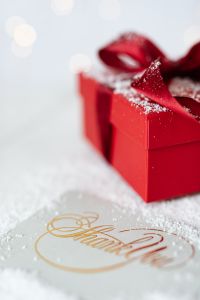 Kaboompics - Red Christmas Present beside a Gold Thank You Card, Soft-Focus Holiday Still Life