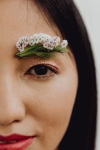 Kaboompics - Eye Close-Up with Sparkling Makeup and White Blossom Eyebrow Styling