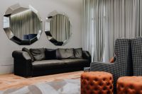 Kaboompics - Black Leather Sofa and Decorative Wall Mirrors in Modern Living Room