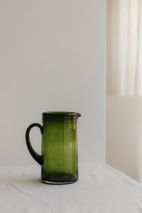 Kaboompics - Green Glass Pitcher beside a Bright Window with Copy Space