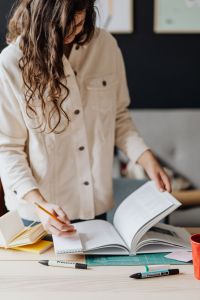 Kaboompics - Woman Turning Pages in Open Book