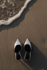 Kaboompics - Silver Pointed Heels on Wet Sand beside the Shore