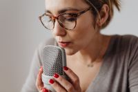 Kaboompics - Woman Holding a Studio Microphone Close while Whispering for ASMR Audio