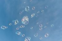 Kaboompics - Colorful Soap Bubbles Floating against a Blue Sky Background