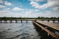 Kaboompics - Beautiful blonde woman on a wooden pier by the lake