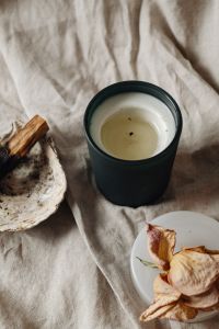 Kaboompics - Minimal Black Candle And Palo Santo On Crumpled Fabric