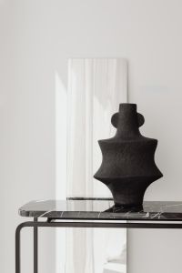 Kaboompics - Black Ceramic Vase On Marble Console Against White Wall