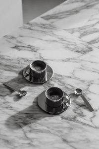 Kaboompics - Two Chrome Coffee Cups on Arabescato Marble