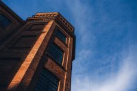 Kaboompics - Sunlit Brick Loft Tower Against Blue Sky