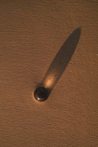Kaboompics - Black Glass Sphere Casting a Shadow on Wet Sand