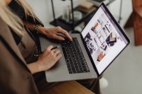 Kaboompics - Female Interior Stylist Reviewing Design Portfolio on Laptop