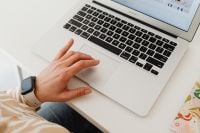 Kaboompics - Close-Up Laptop Trackpad and Smartwatch at Minimal Work Desk