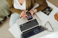 Kaboompics - Overhead Remote Work Setup with Smartphone on Laptop Keyboard