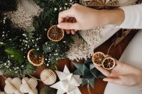Kaboompics - Hands Arranging Paper Stars on Christmas Wreath