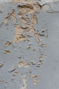 Kaboompics - Peeling Gray Paint Exposing Rough Plaster, Distressed Wall Background for Graphic Design