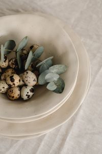 Kaboompics - Quail Eggs And Eucalyptus Leaves In Ceramic Bowl