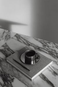 Kaboompics - Chrome Coffee Cup on Notebook with Pen and Arabescato Marble