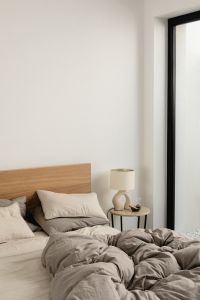 Kaboompics - Cozy Gray Bed with Bedside Lamp by a Window