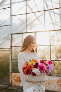Kaboompics - Woman Holding Dahlia Bouquet In A Sunlit Greenhouse