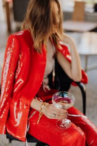 Kaboompics - Cropped Red Blazer and Champagne Glass at New Year Celebration