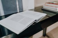 Kaboompics - Open Book on Glossy Black Desk in Modern Interior