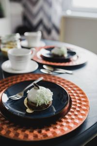 Sweet little white chocolate dessert on a blue saucer in a cake shop