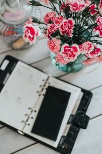 Kaboompics - Organizer, mobile phone and lovely pink flowers