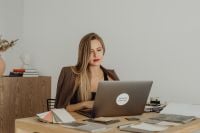 Kaboompics - Female Interior Designer Working on Laptop With Material Samples