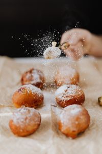 Kaboompics - Close-Up of Powdered Sugar Showering over Sugar-Dusted Paczki Doughnuts