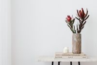 Kaboompics - Red Dried Flowers in Textured Vase on Books