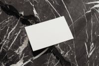 Kaboompics - Blank White Business Card Mockup on Black Marble with Angled Shadows, Horizontal Layout
