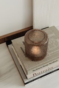 Kaboompics - Top View of a Glass Votive on Stacked Design Books, Neutral Interior Styling