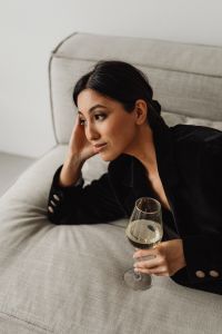 Kaboompics - Close-Up Asian Woman Relaxing on a Sofa with White Wine