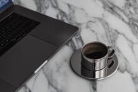 Kaboompics - Laptop and Chrome Espresso Cup on White Veined Marble, Overhead Home Office Coffee Scene